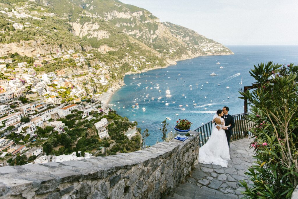 A couple on the Amalfi coast with their wedding team