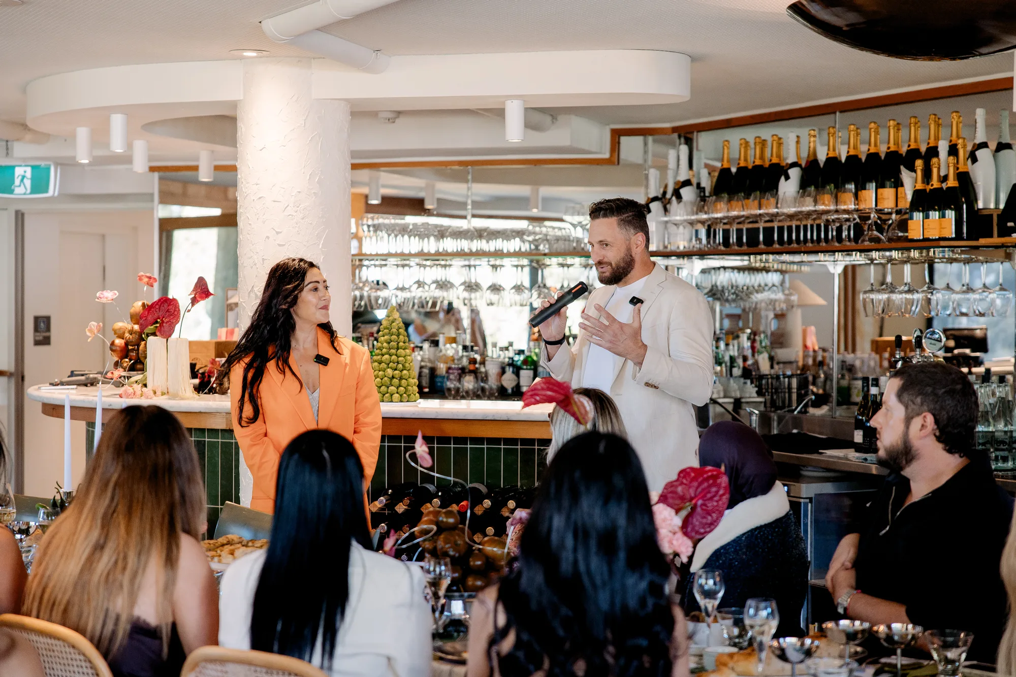 Hosts presenting to guests at a Wedded Exchange event