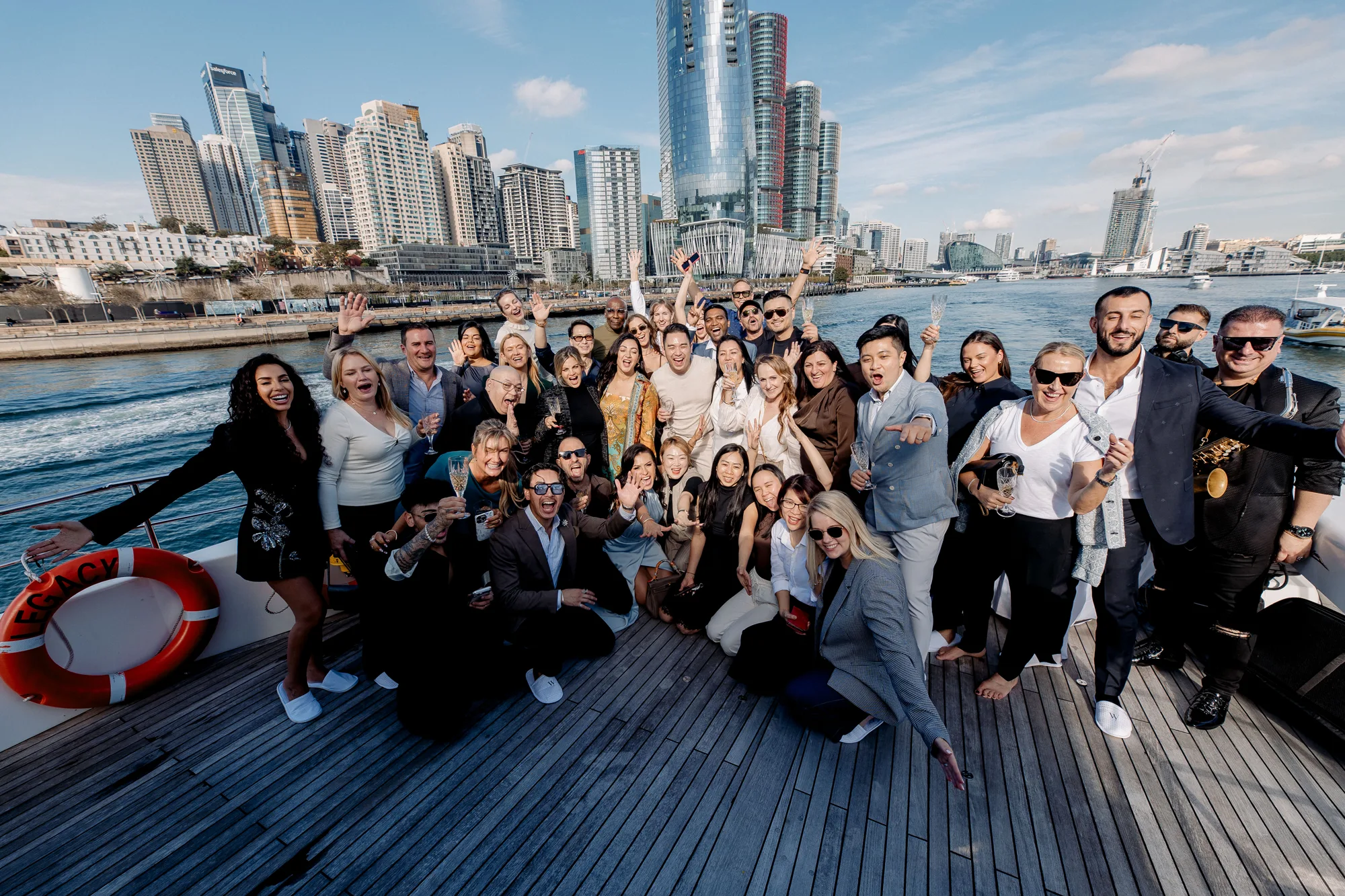 An Experience with Wedded group aboard a boat with the Sydney skyline behind