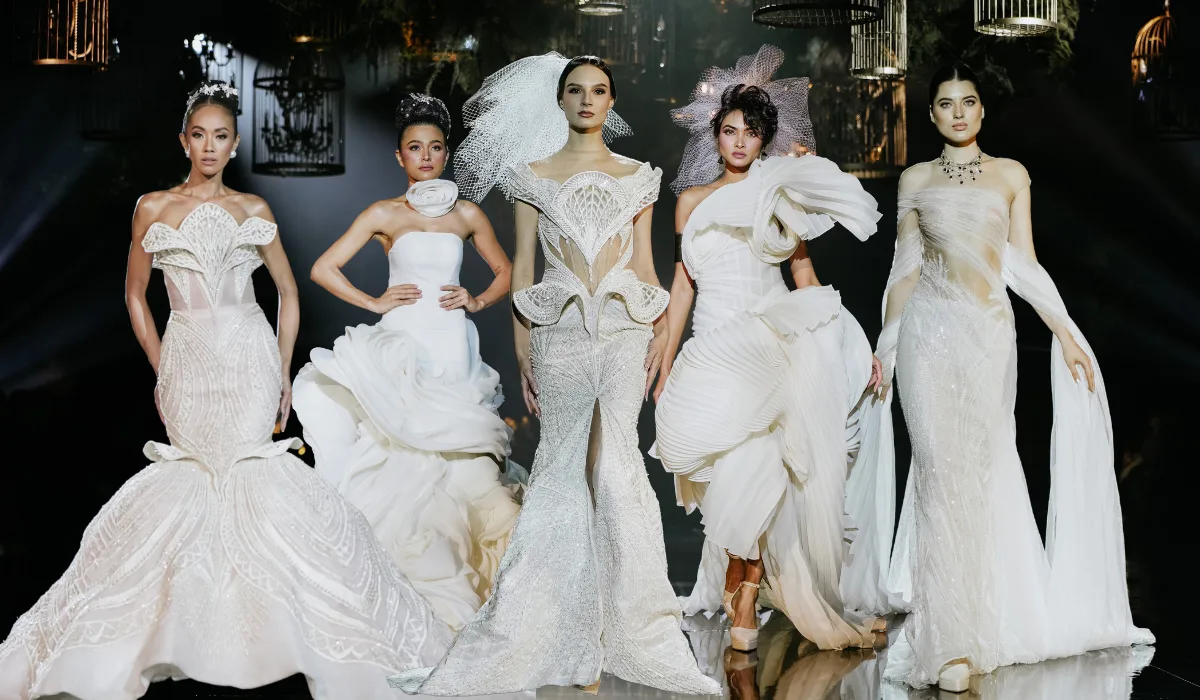 Five models in couture bridal gowns at a Wedded World: Her runway showcase