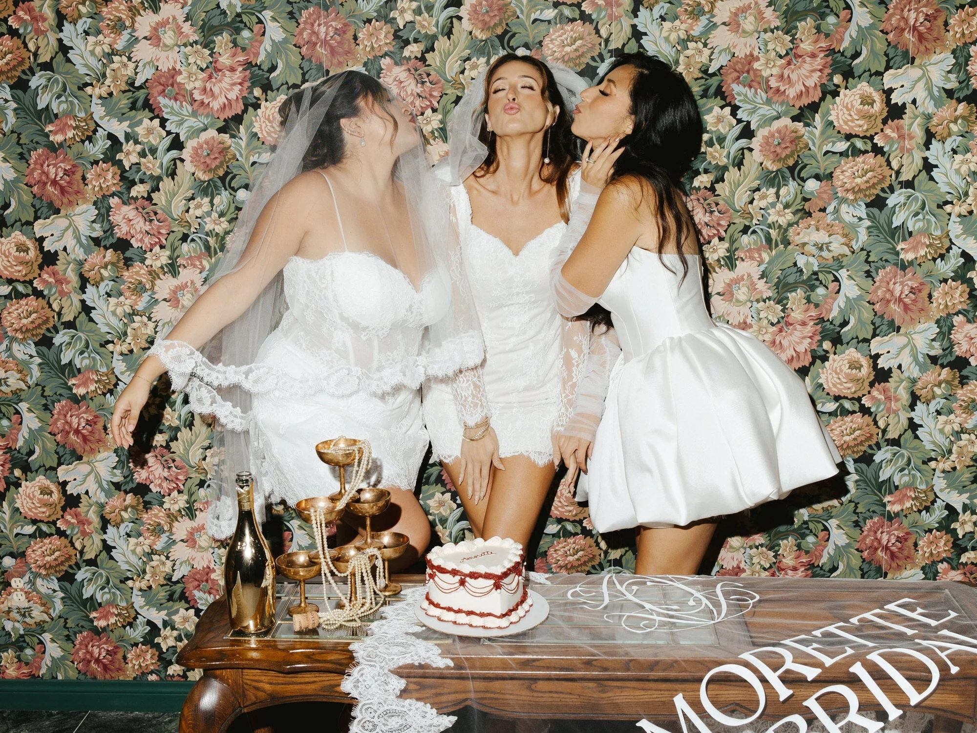 Guests in bridal styling posing at a Wedded World: Her activation