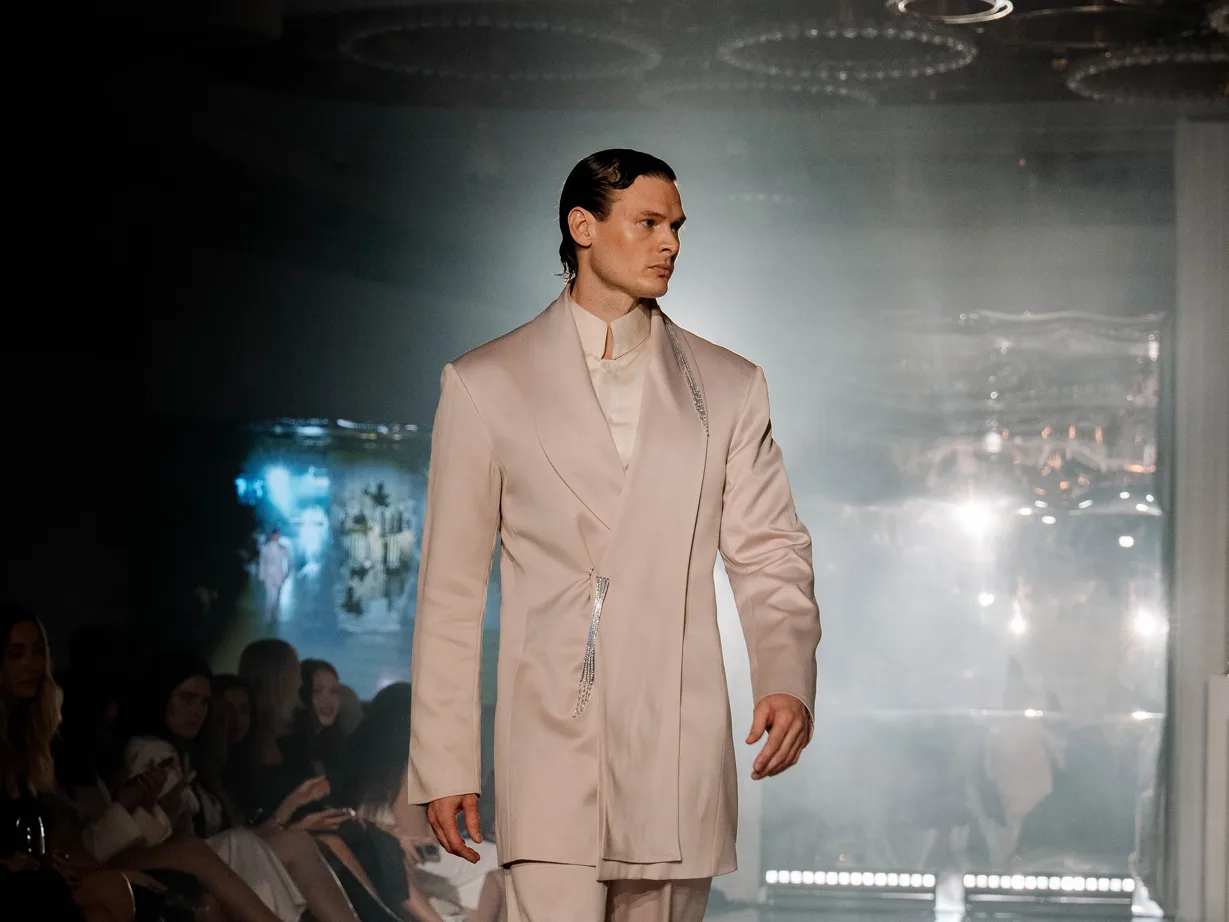 A model on the runway in a tailored suit at a Wedded World: Him showcase