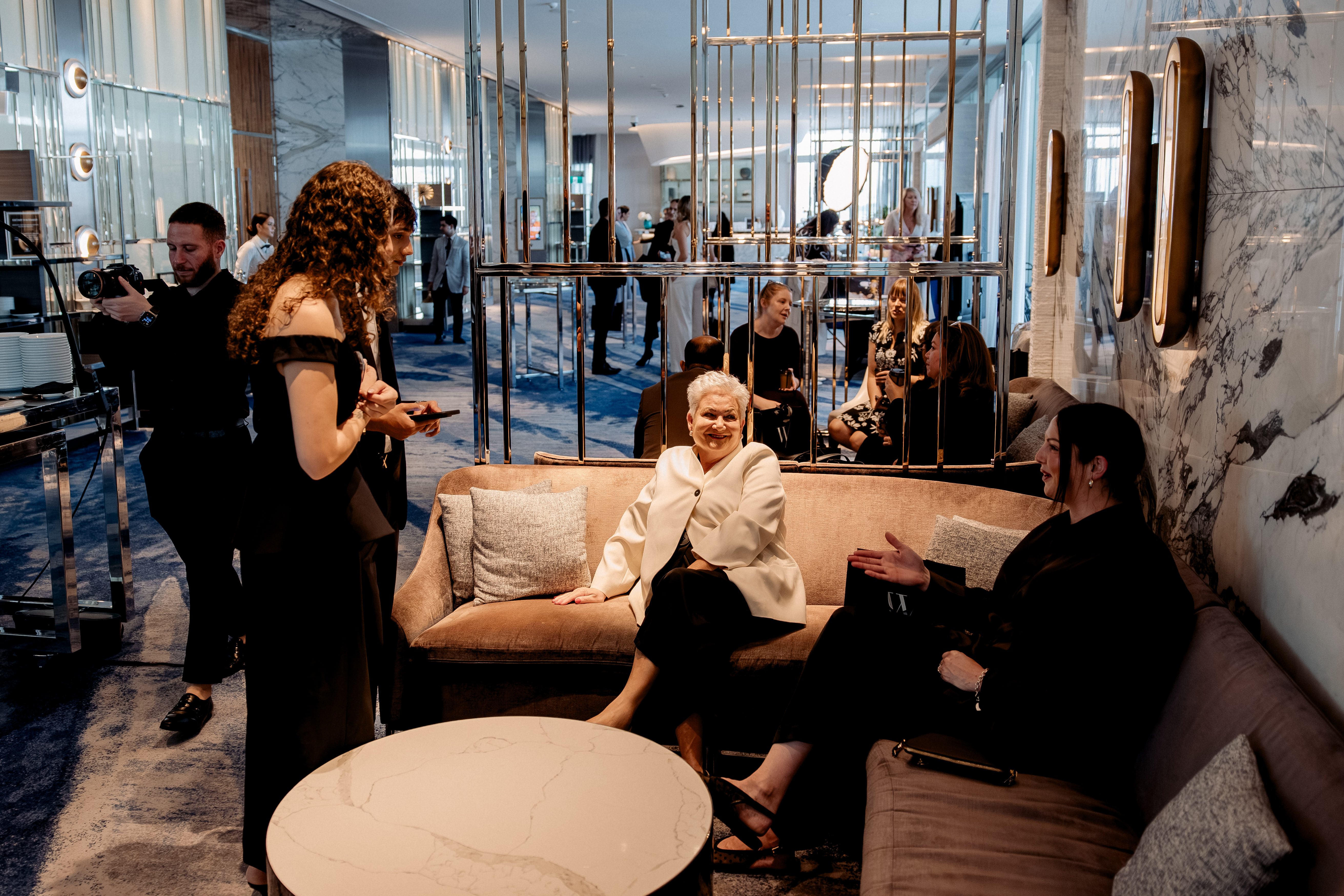 An editorial portrait of a couple in couture against grand architecture