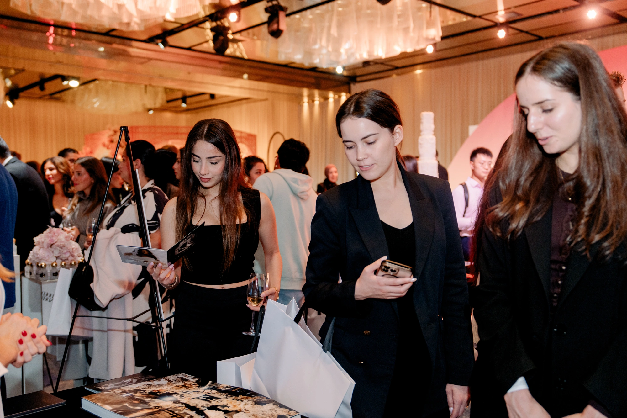 Attendees browsing exhibitor lookbooks and brochures at Wedded World