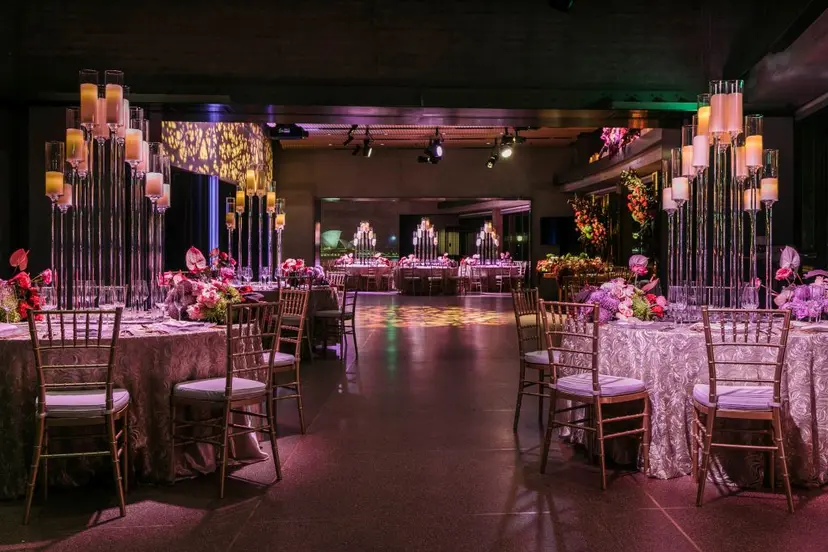 A wedding reception hall set for guests