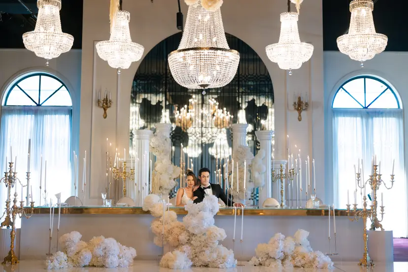 A grand chandelier-lit wedding ballroom