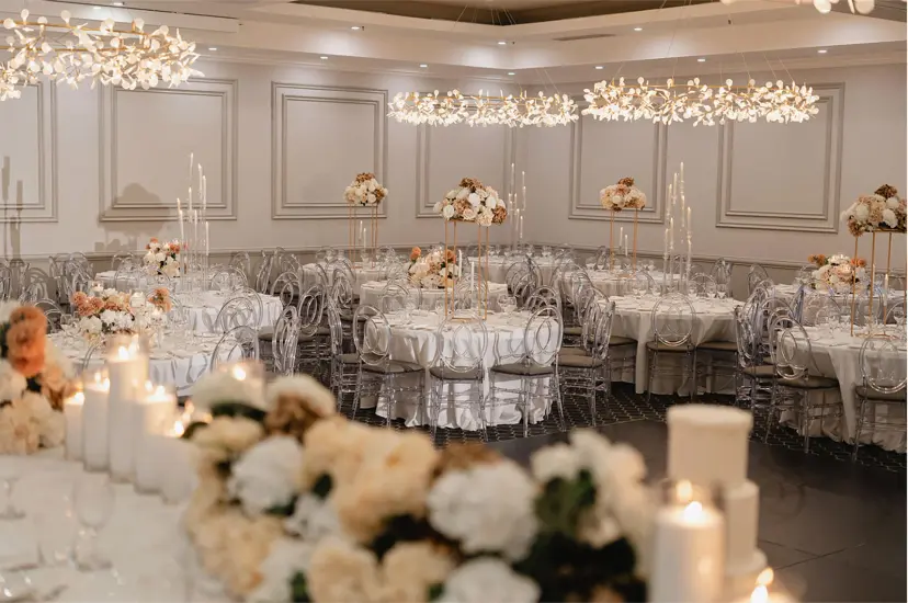Candlelit round tables laid out for a wedding reception