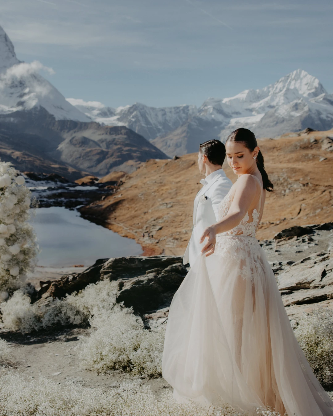 Couple in the mountains beside an alpine lake