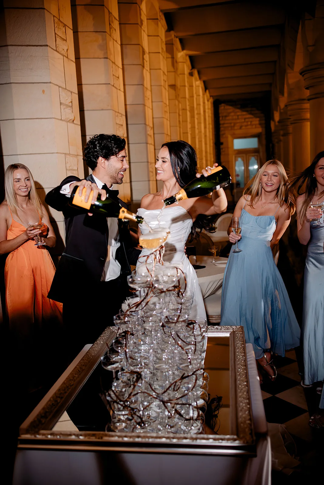 Bride and groom pouring a champagne tower