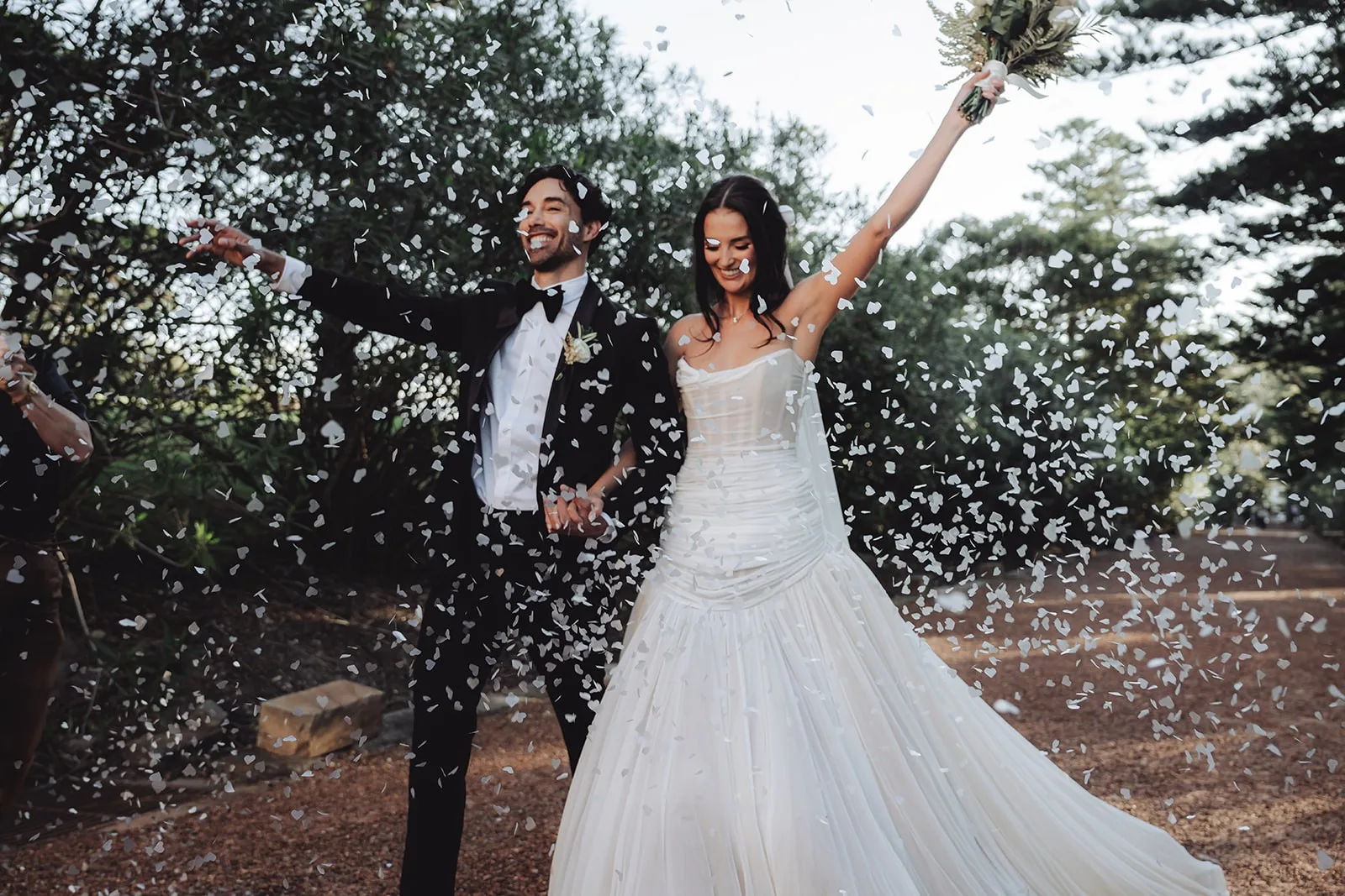 A couple walking out through a shower of confetti