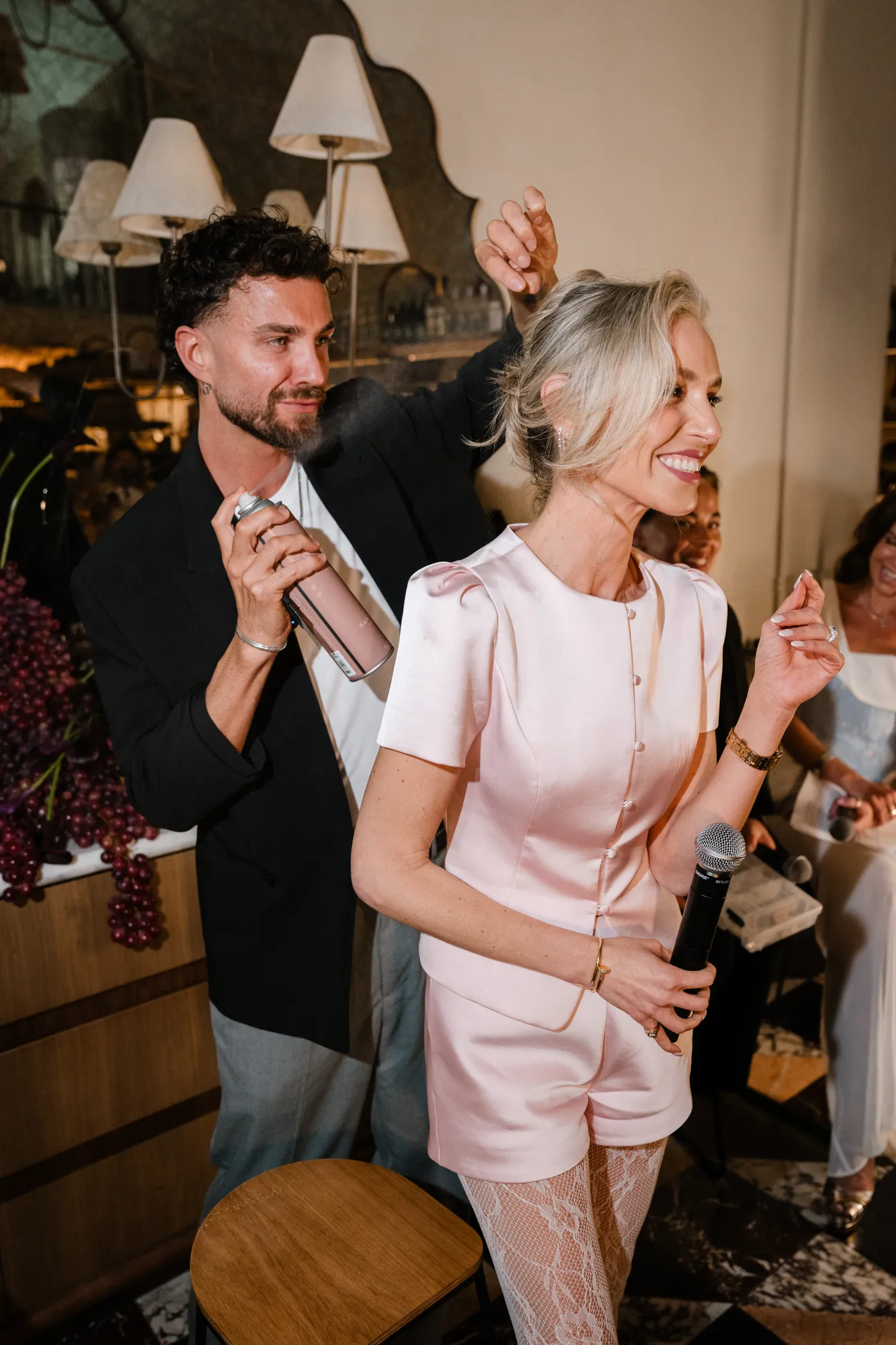 A stylist finishing a guest's hair at the Wedded Salon