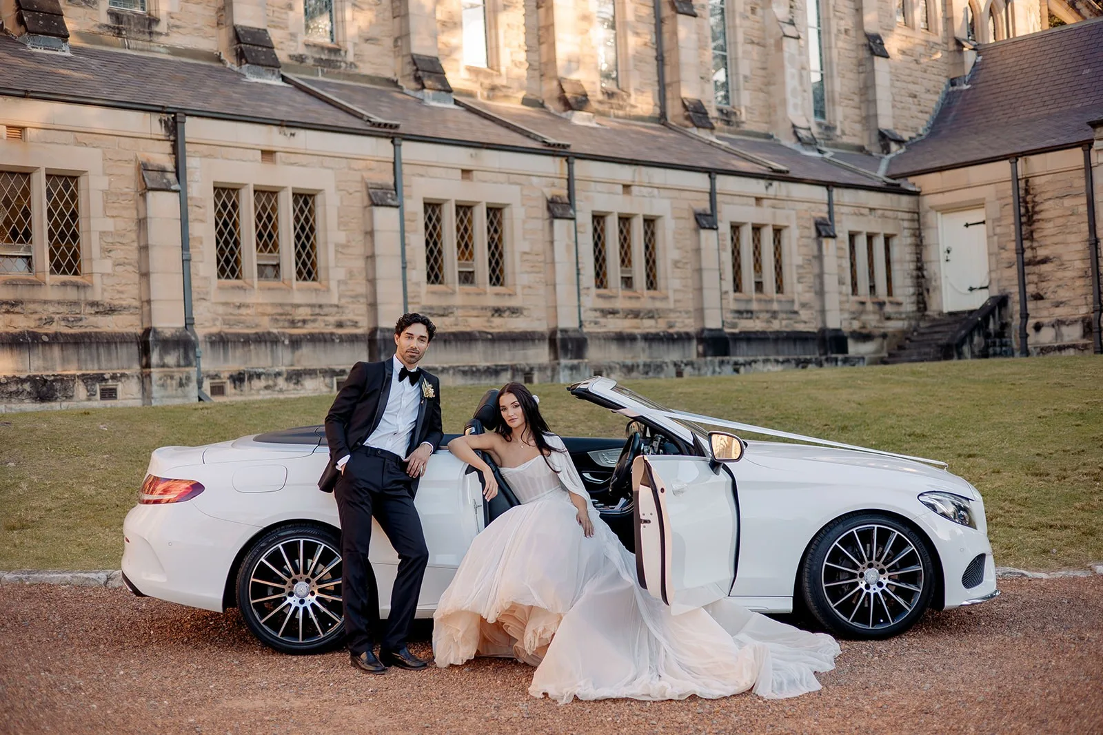 Bride and groom with their wedding car